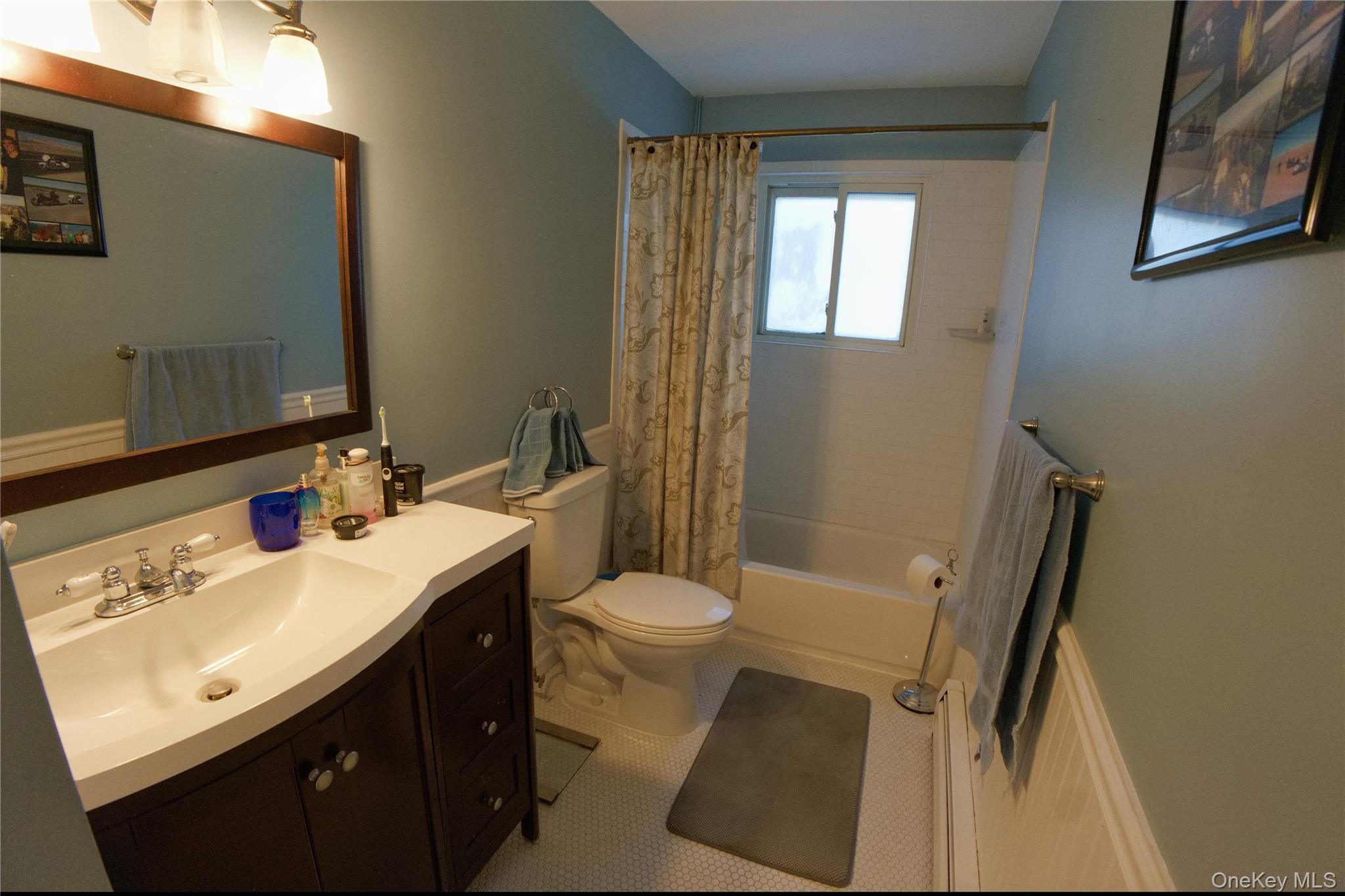 215 Lakeside Trail Ridge, NY 11961 - Photo 11 of 24 a bathroom with a sink a toilet a mirror and shower