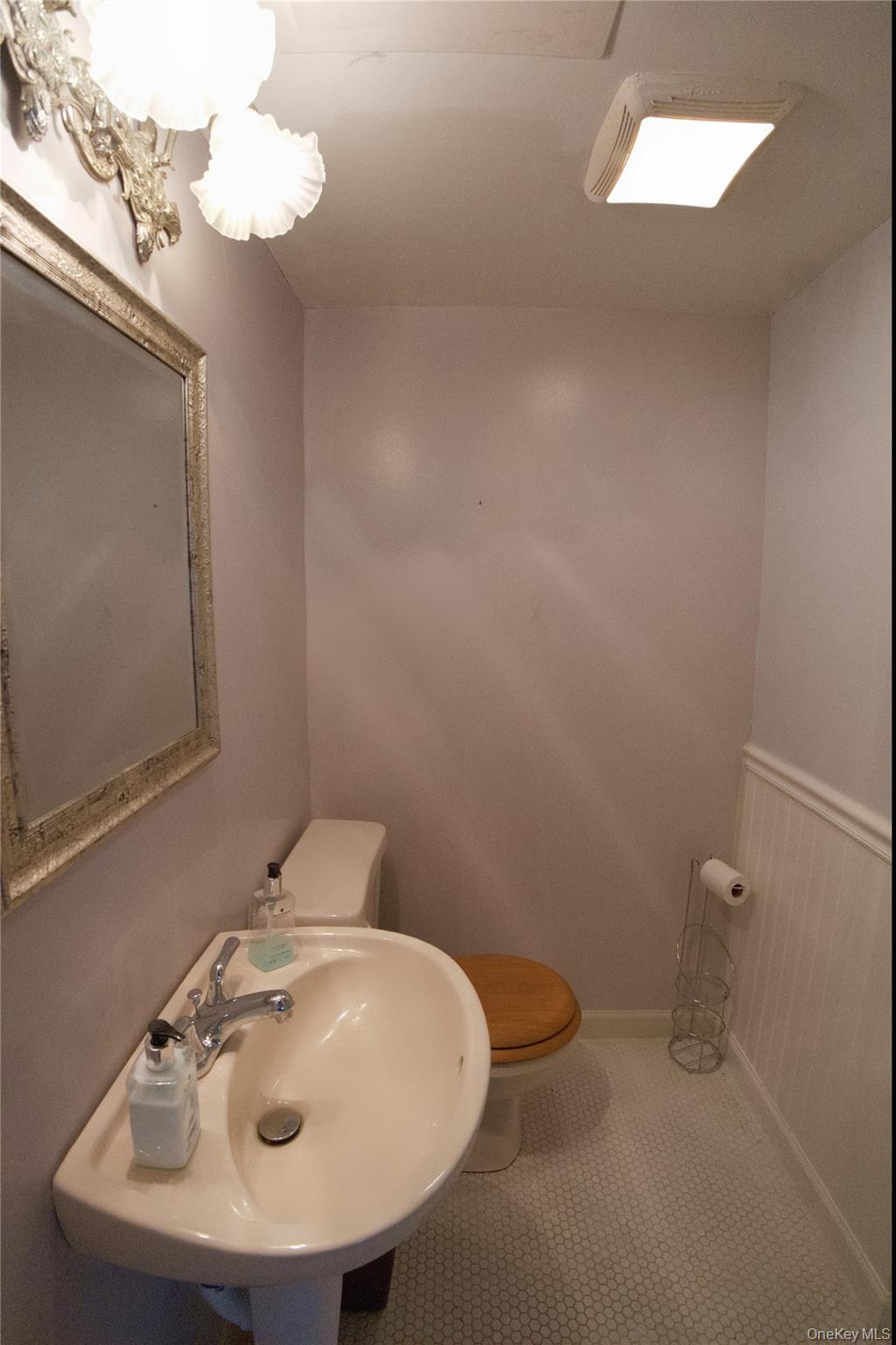 215 Lakeside Trail Ridge, NY 11961 - Photo 12 of 24 a bathroom with a sink a toilet and mirror