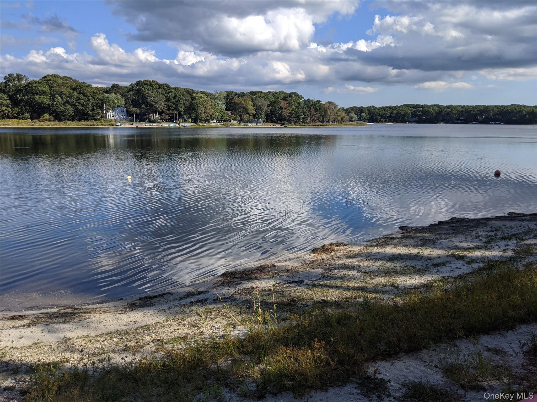 215 Lakeside Trail Ridge, NY 11961 - Photo 14 of 24 a view of a lake in a city