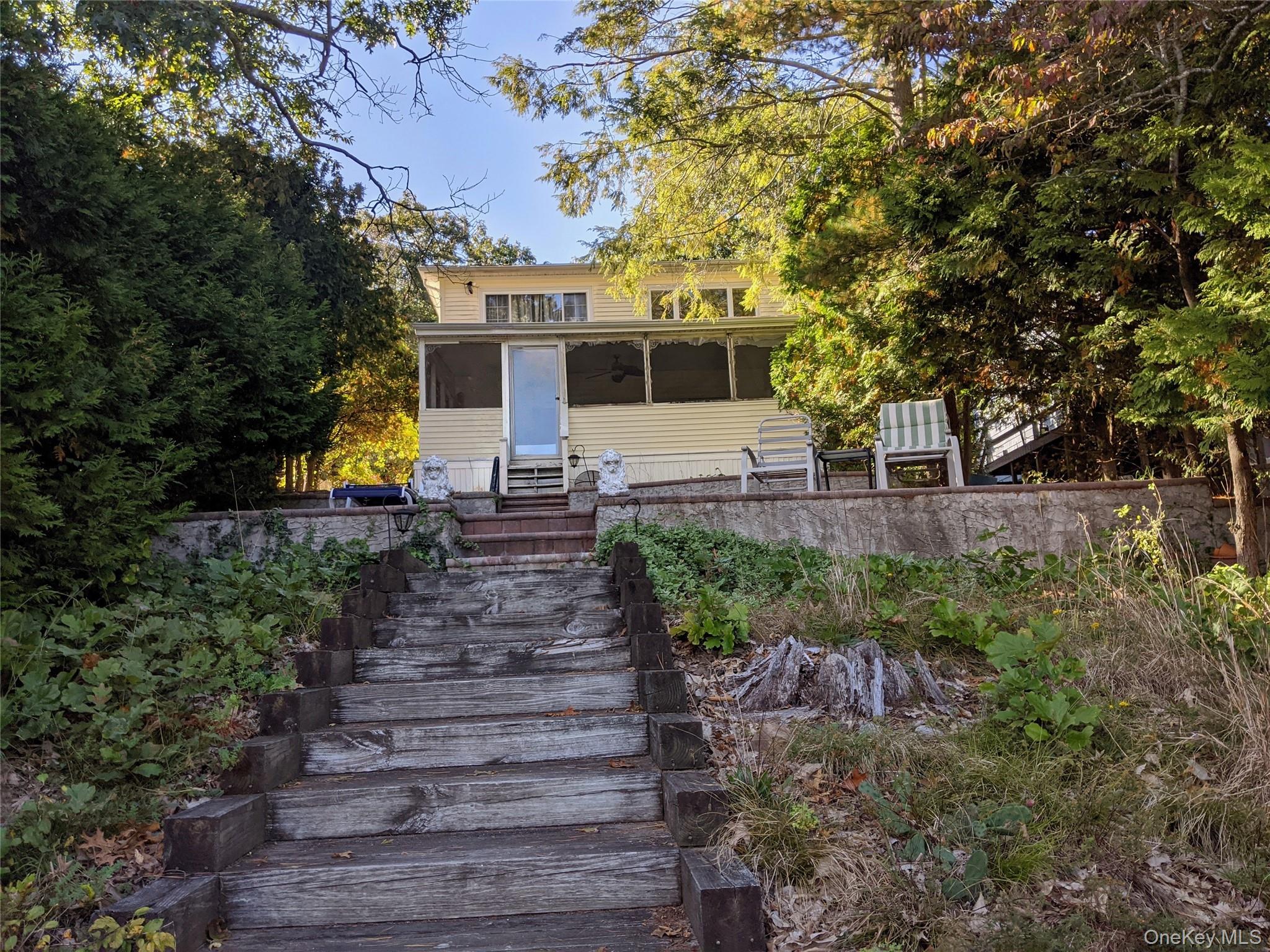 215 Lakeside Trail Ridge, NY 11961 - Photo 16 of 24 a front view of a house with a yard
