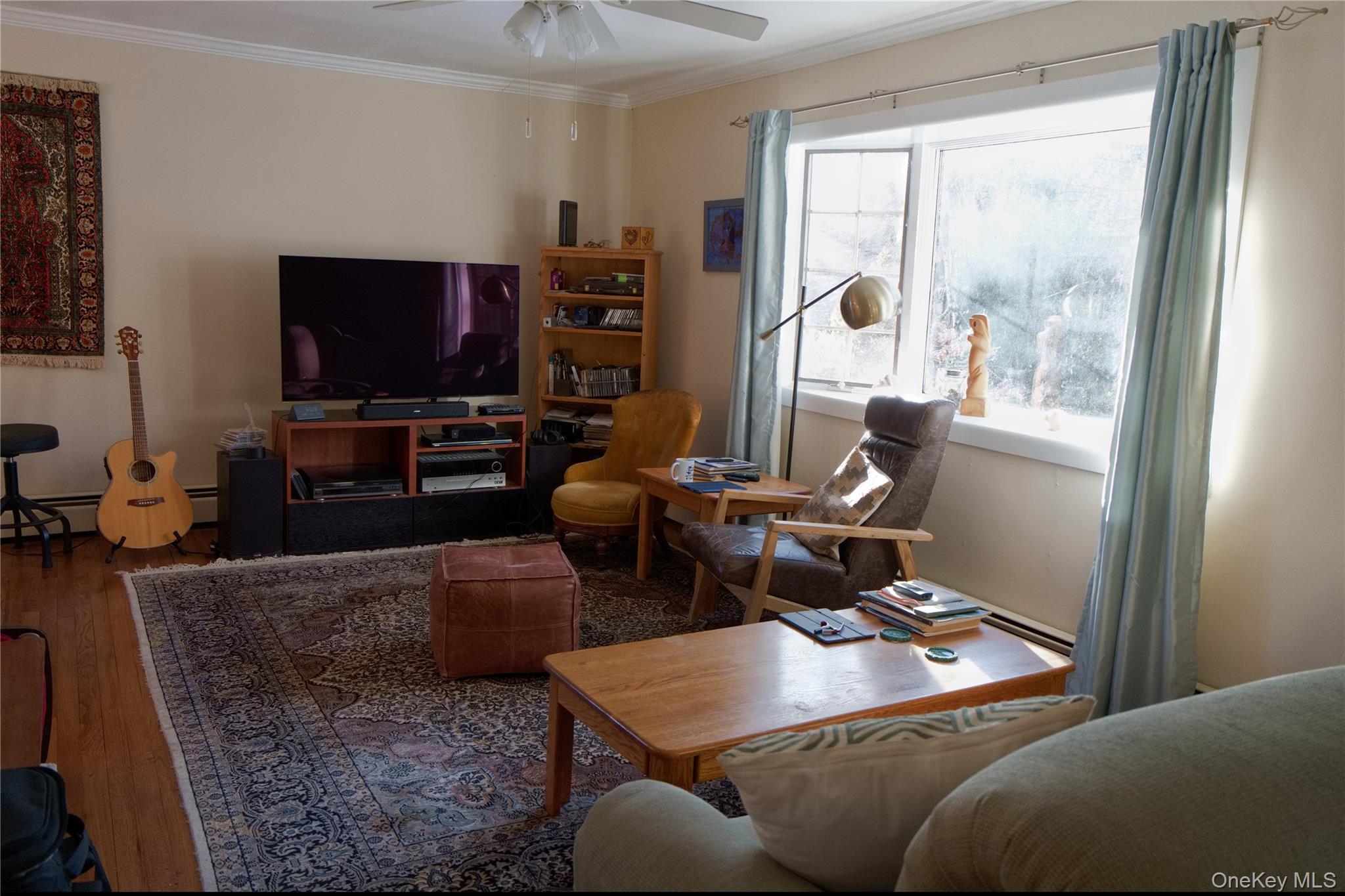 215 Lakeside Trail Ridge, NY 11961 - Photo 5 of 24 a living room with furniture a flat screen tv and a large window
