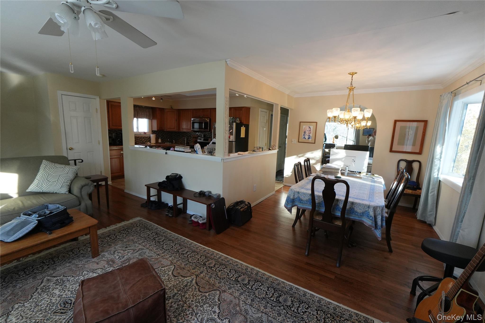 215 Lakeside Trail Ridge, NY 11961 - Photo 6 of 24 a living room with furniture and a chandelier