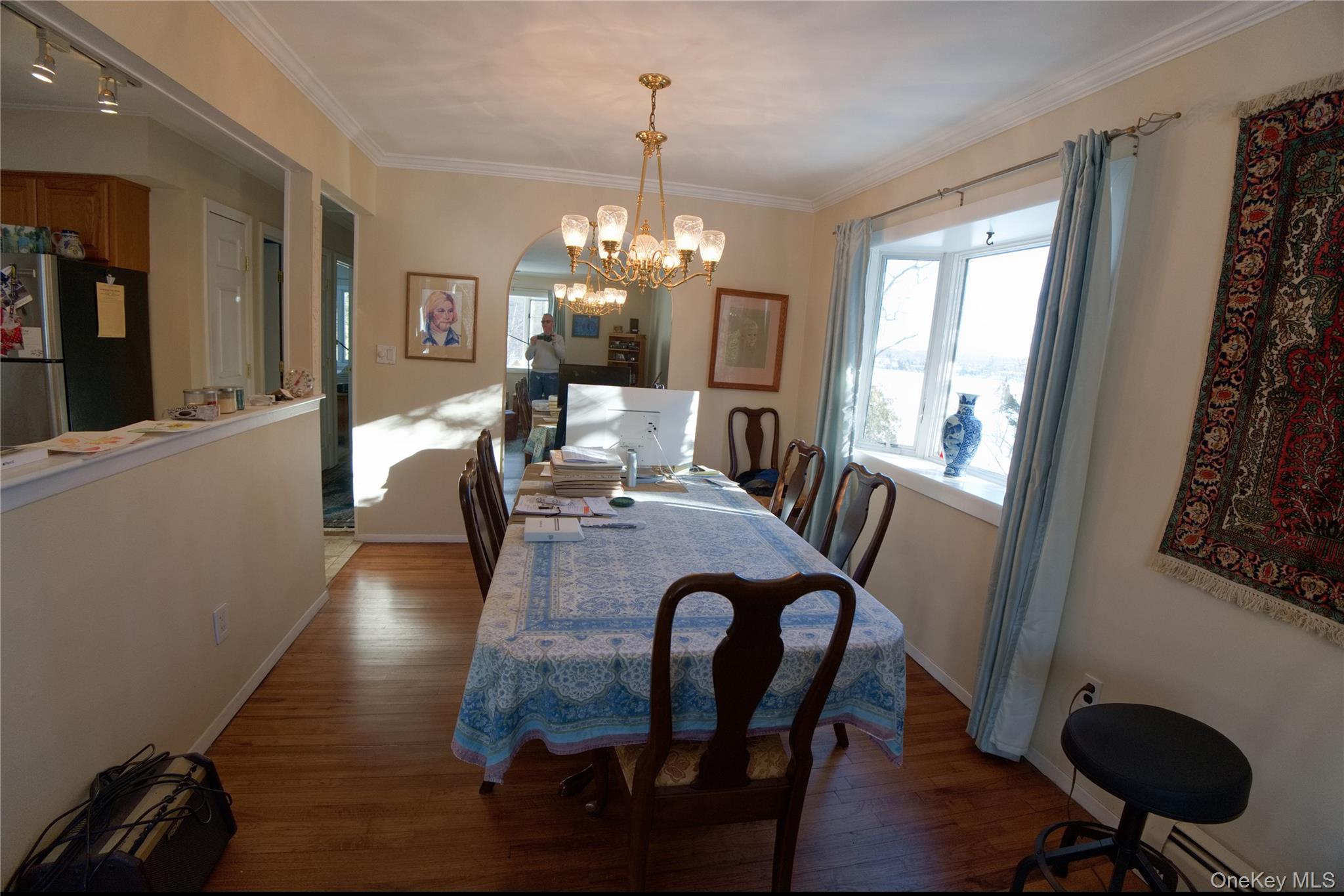 215 Lakeside Trail Ridge, NY 11961 - Photo 7 of 24 a dining room with furniture a chandelier and wooden floor