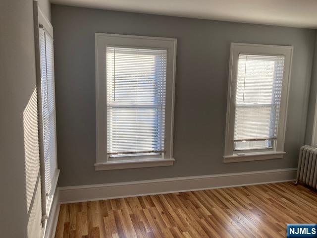 129 Union Street Hackensack, NJ 07601 - Photo 7 of 10 an empty room with wooden floor and windows