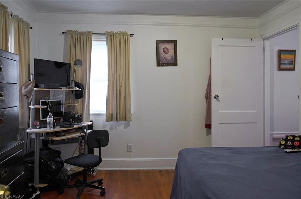 408 Hickory Chapel Road High Point, NC 27260 - Photo 17 of 23 Bedroom 2 off the living room has hardwood floors and wide moldings.