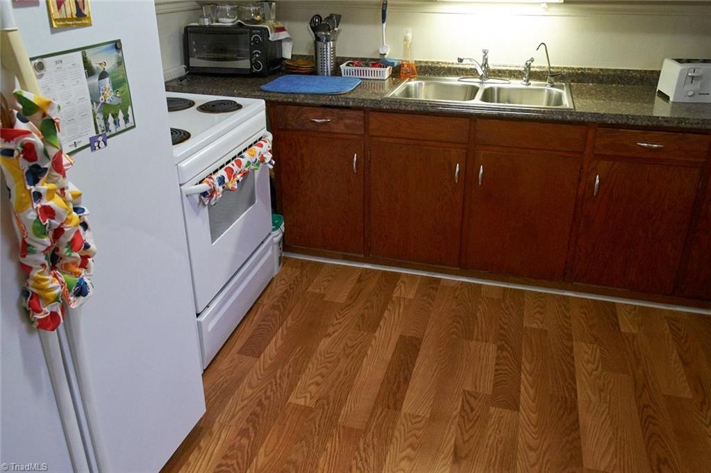 408 Hickory Chapel Road High Point, NC 27260 - Photo 8 of 23 New in 2017: Laminate flooring, Formica counters, sink and fixtures.