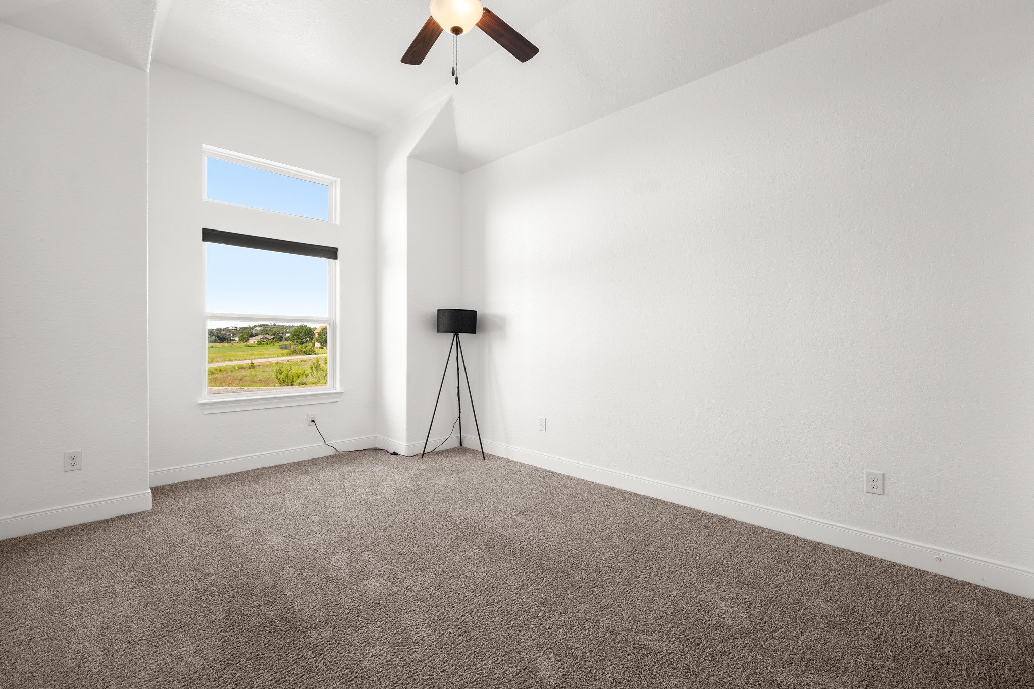 128 Hiram Cook Blanco, TX 78606 - Photo 24 of 40 Bedroom featuring a tray ceiling, ceiling fan, and light-colored carpet
