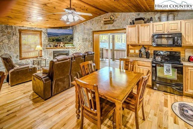a dining table with chairs and kitchen view
