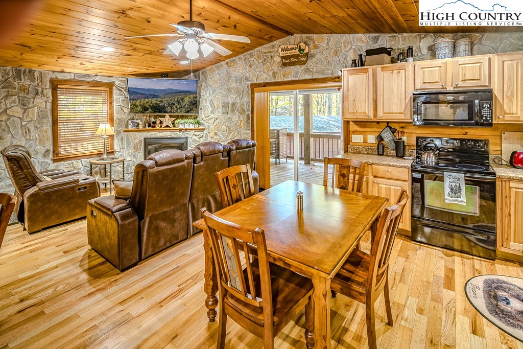 719 Pine Ridge Road Beech Mountain, NC 28604 - Photo 12 of 32 a dining table with chairs and kitchen view