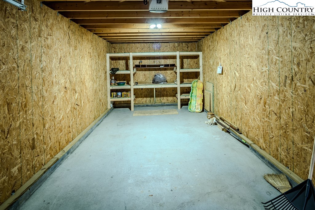719 Pine Ridge Road Beech Mountain, NC 28604 - Photo 29 of 32 a view of an empty room with a fireplace and a window