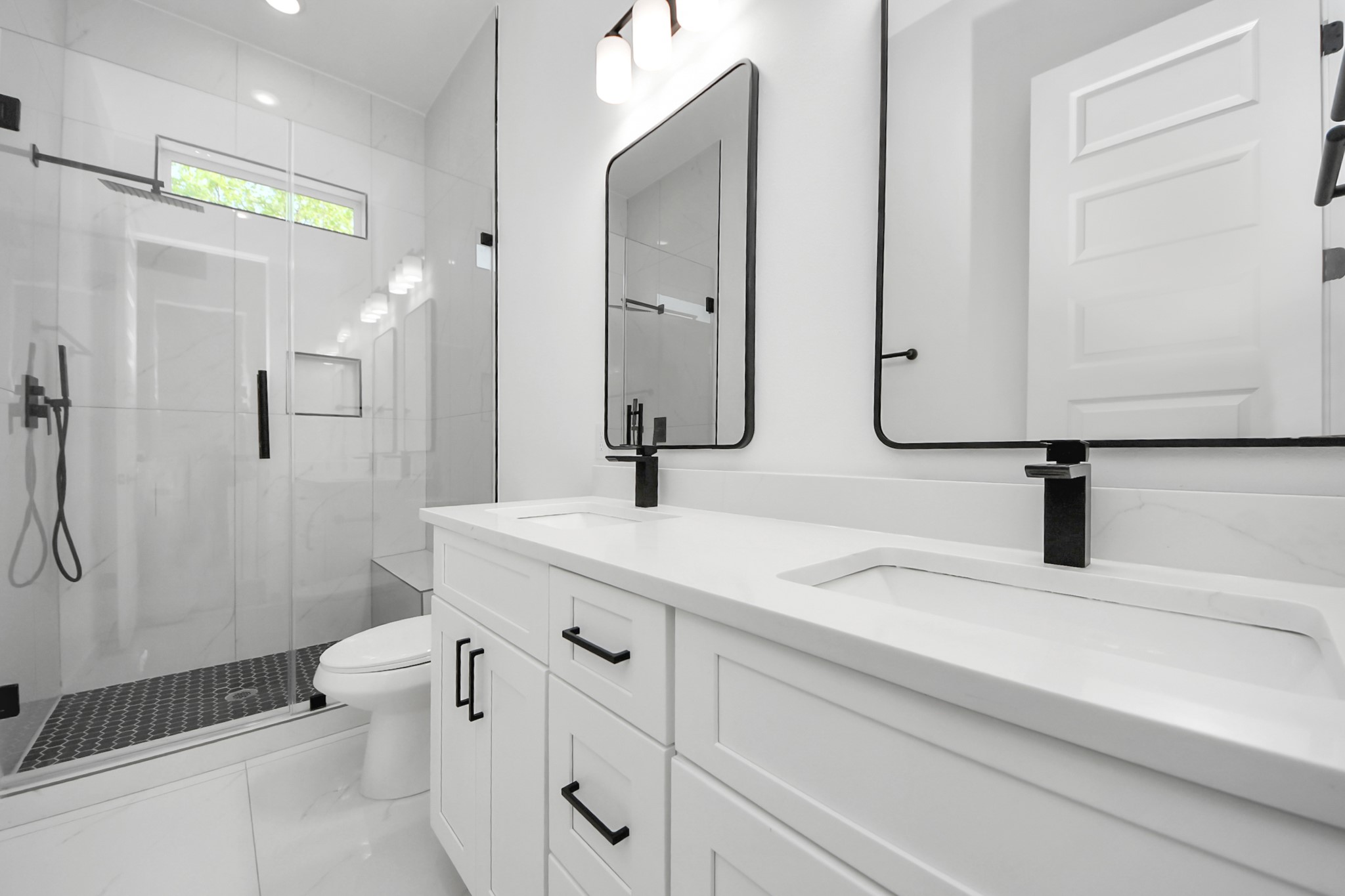 7935 Sunnyhill Street Houston, TX 77088 - Photo 16 of 21 a bathroom with a double vanity sink toilet and shower