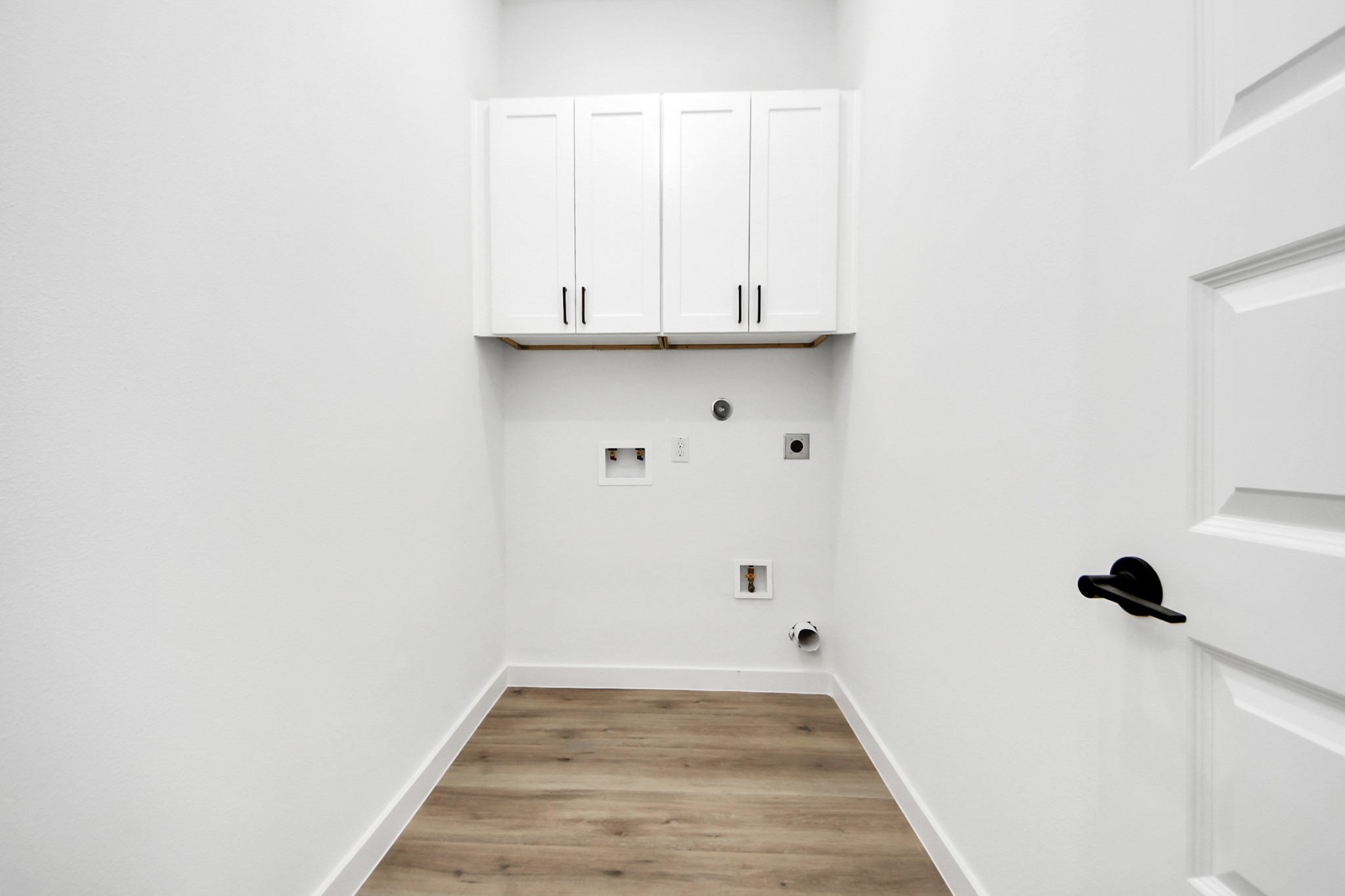 7935 Sunnyhill Street Houston, TX 77088 - Photo 20 of 21 a view of a utility room with wooden floor