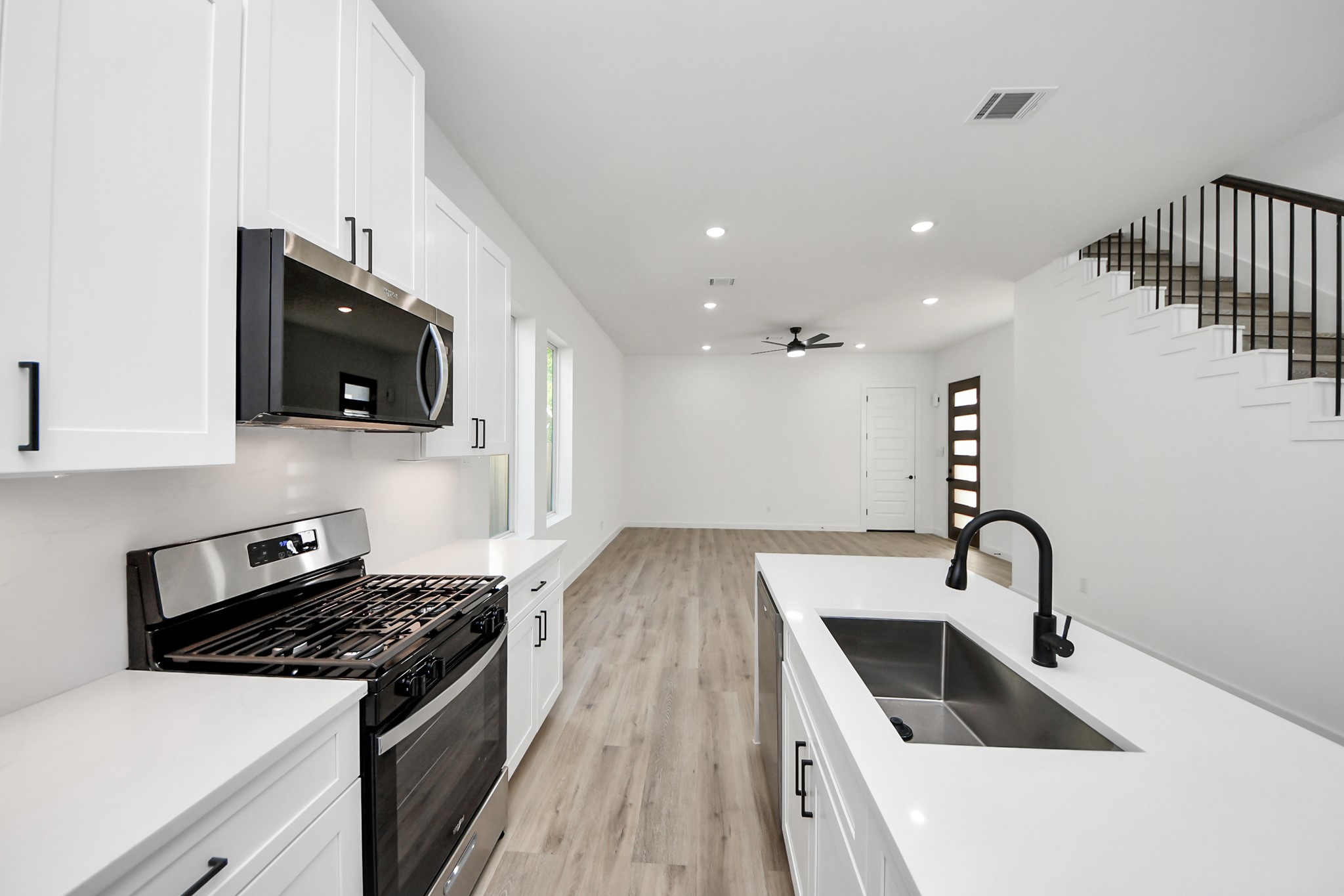7935 Sunnyhill Street Houston, TX 77088 - Photo 7 of 21 a kitchen that has a sink and a stove top oven