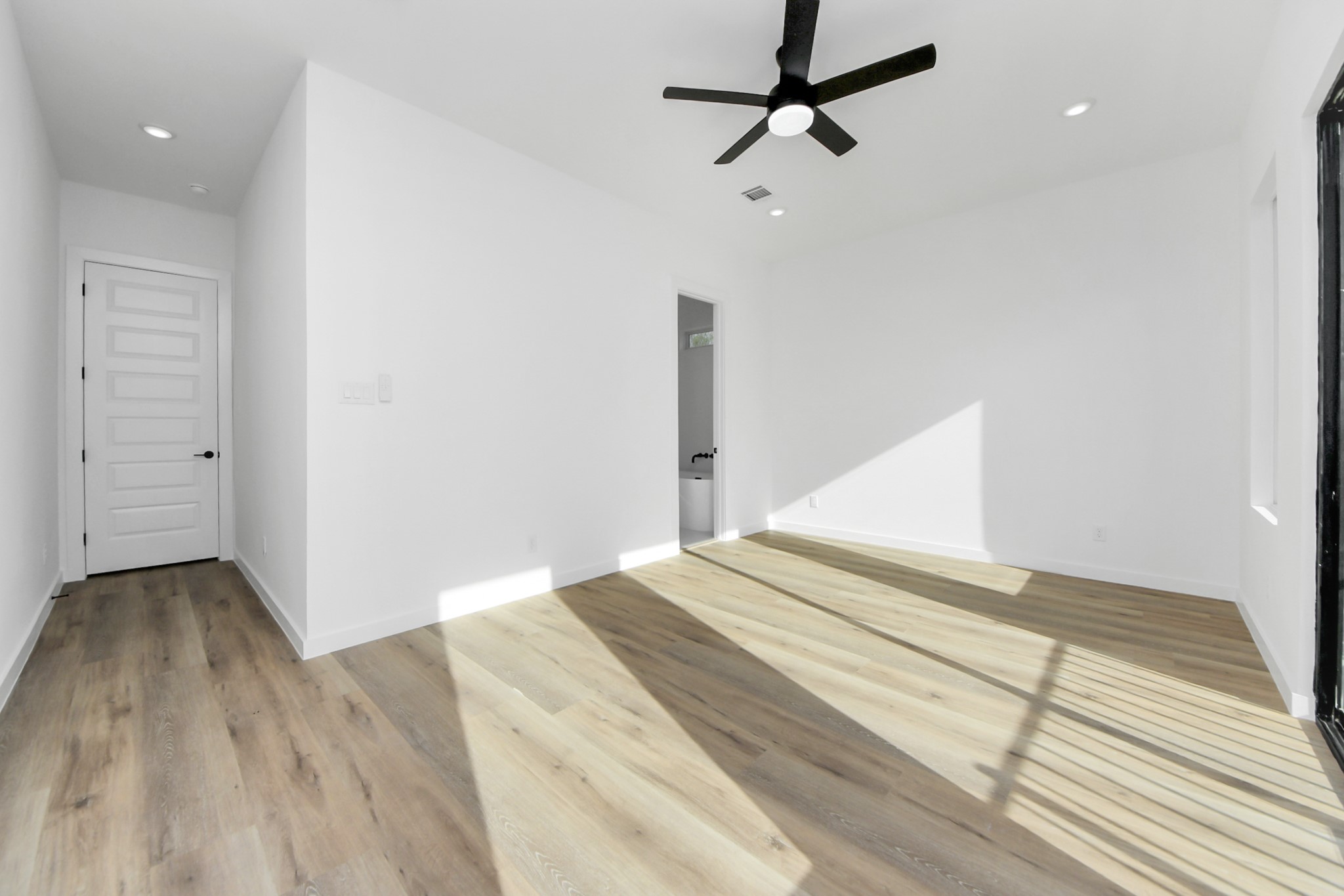 7935 Sunnyhill Street Houston, TX 77088 - Photo 10 of 21 a view of a big room with wooden floor and windows