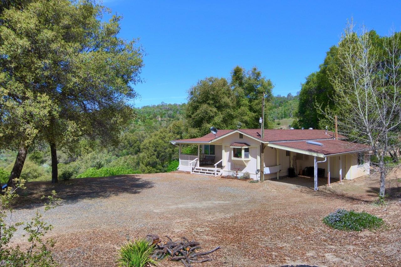 40640 Taylor Mountain Road Oakhurst, CA 93644 - Photo 1 of 62 a front view of a house with a garden