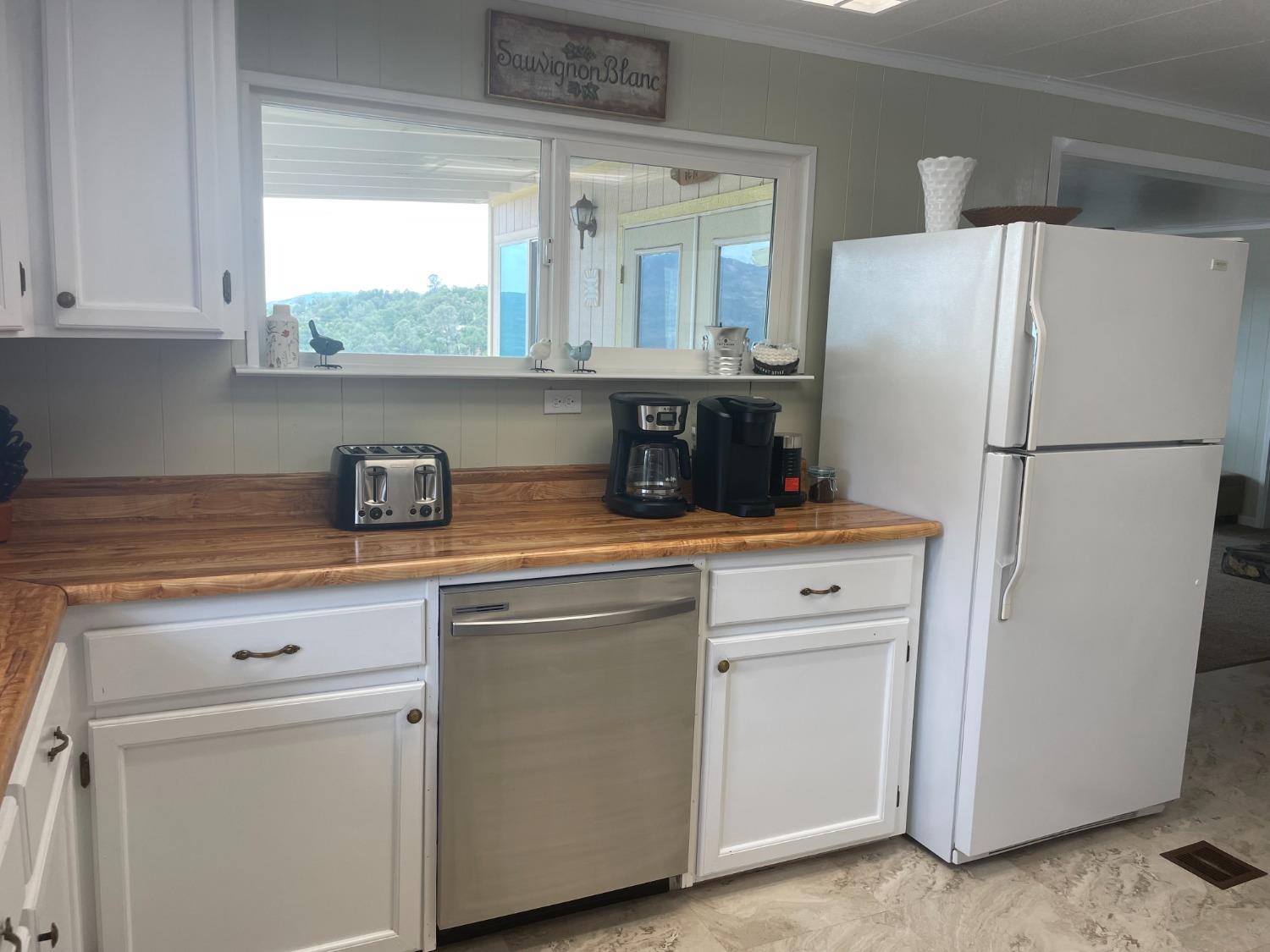 40640 Taylor Mountain Road Oakhurst, CA 93644 - Photo 21 of 62 a kitchen with a refrigerator sink and cabinets