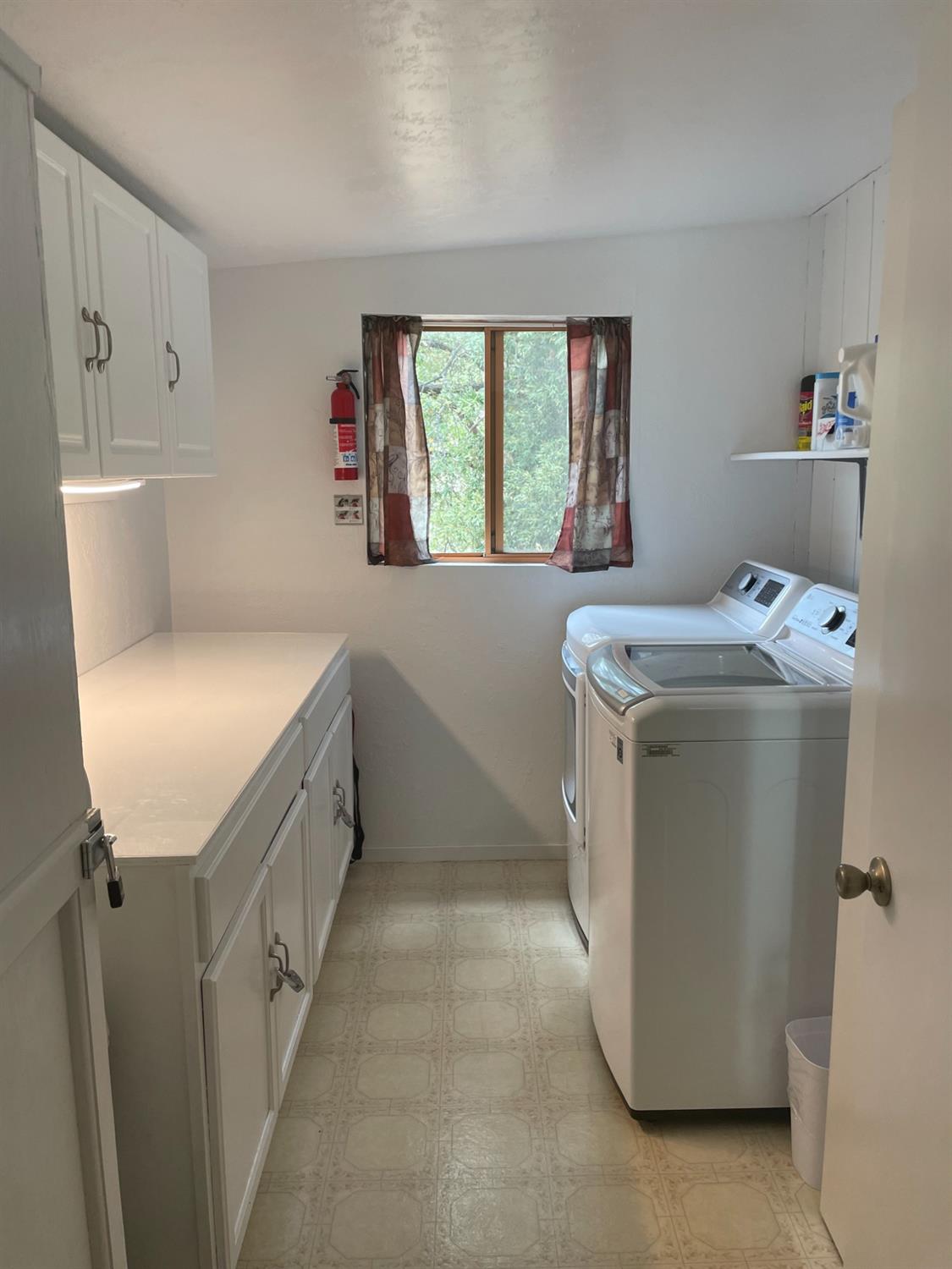 40640 Taylor Mountain Road Oakhurst, CA 93644 - Photo 23 of 62 a utility room with cabinets washer and dryer