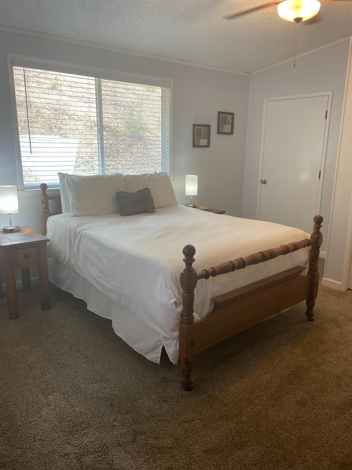 40640 Taylor Mountain Road Oakhurst, CA 93644 - Photo 26 of 62 a bed sitting in a bedroom next to a window