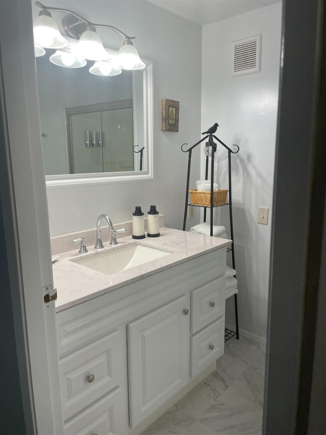 40640 Taylor Mountain Road Oakhurst, CA 93644 - Photo 29 of 62 a bathroom with a sink and a mirror
