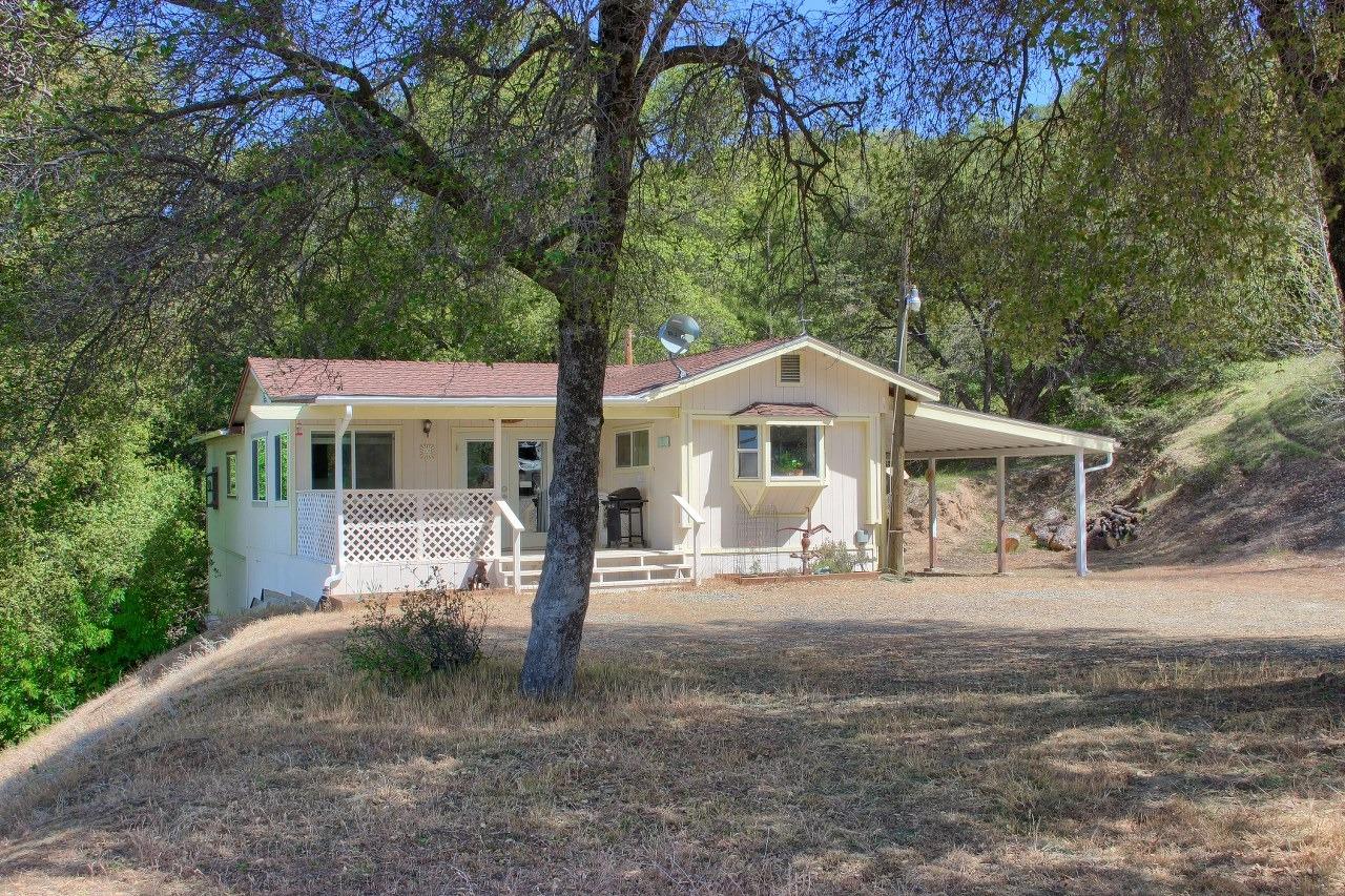 40640 Taylor Mountain Road Oakhurst, CA 93644 - Photo 3 of 62 a front view of a house with a yard