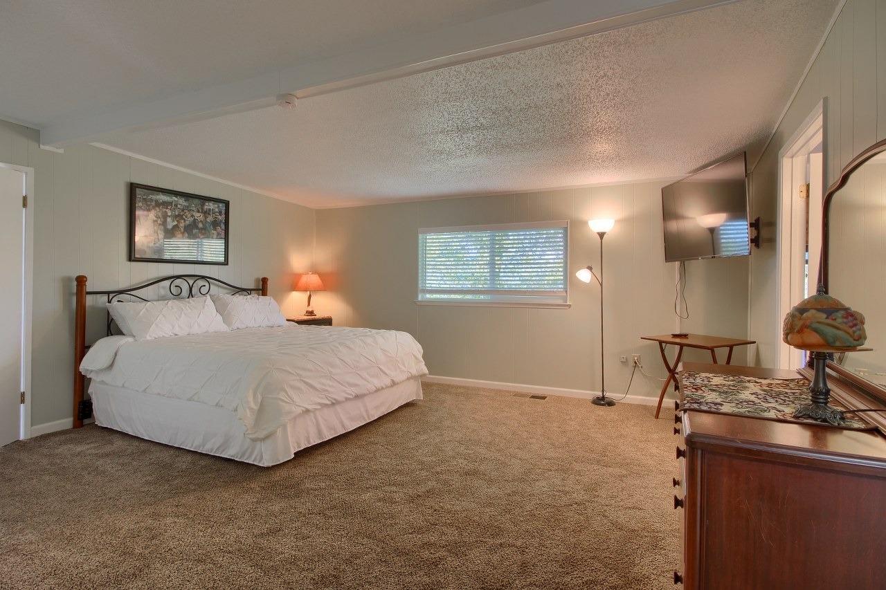 40640 Taylor Mountain Road Oakhurst, CA 93644 - Photo 35 of 62 a bedroom with a bed and wooden floor