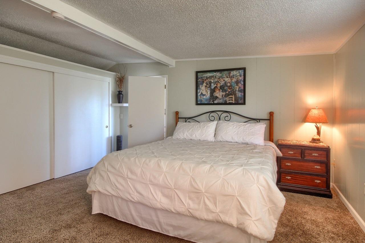 40640 Taylor Mountain Road Oakhurst, CA 93644 - Photo 36 of 62 a bedroom with a bed and a night stand