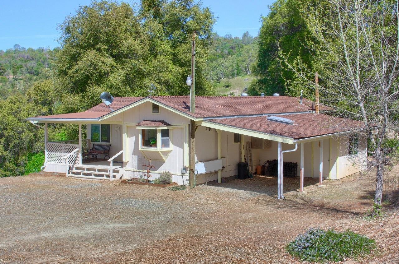 40640 Taylor Mountain Road Oakhurst, CA 93644 - Photo 4 of 62 a front view of a house with a yard