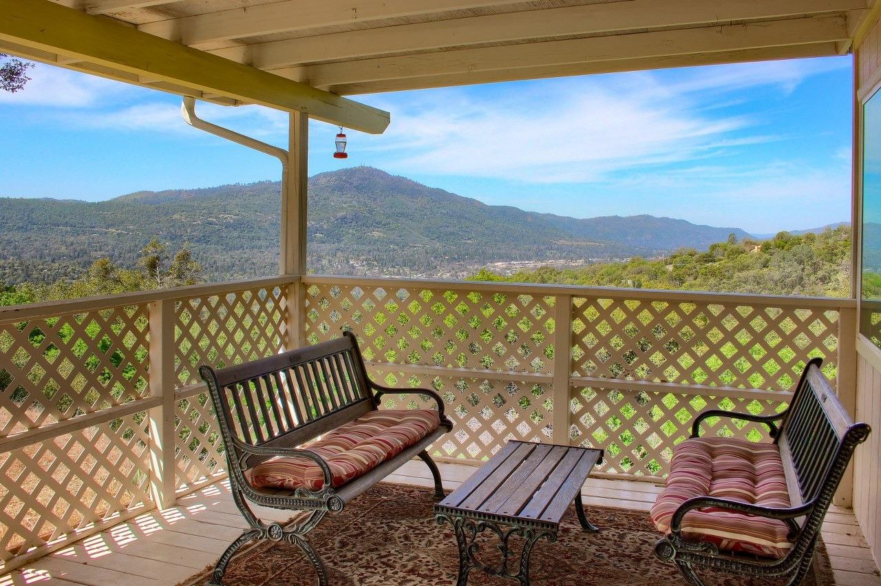 40640 Taylor Mountain Road Oakhurst, CA 93644 - Photo 6 of 62 a view of a chair and table on the balcony