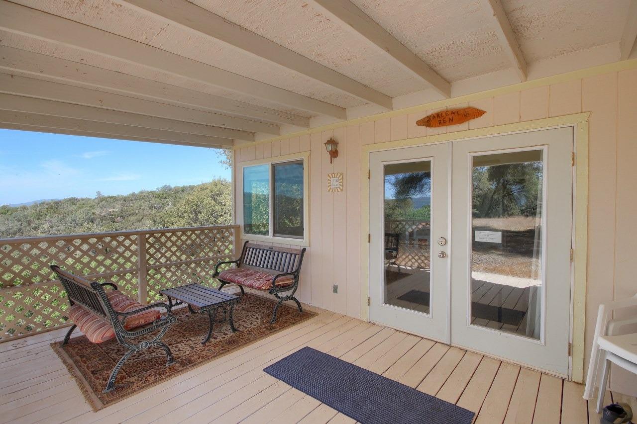 40640 Taylor Mountain Road Oakhurst, CA 93644 - Photo 7 of 62 a view of balcony with furniture and wooden floor