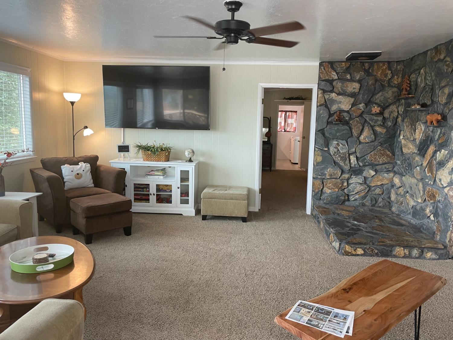 40640 Taylor Mountain Road Oakhurst, CA 93644 - Photo 9 of 62 a living room with furniture and a flat screen tv