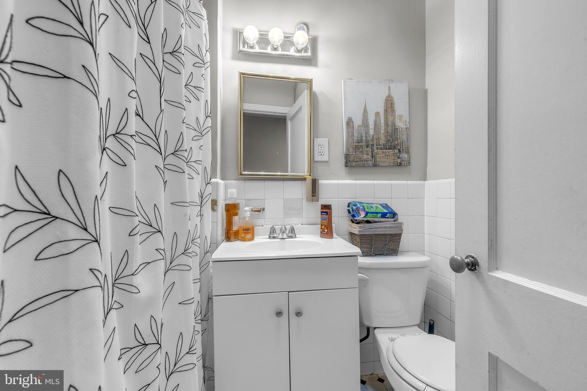 438 Holly Road Lansdowne, PA 19050 - Photo 12 of 17 a bathroom with a toilet sink and mirror