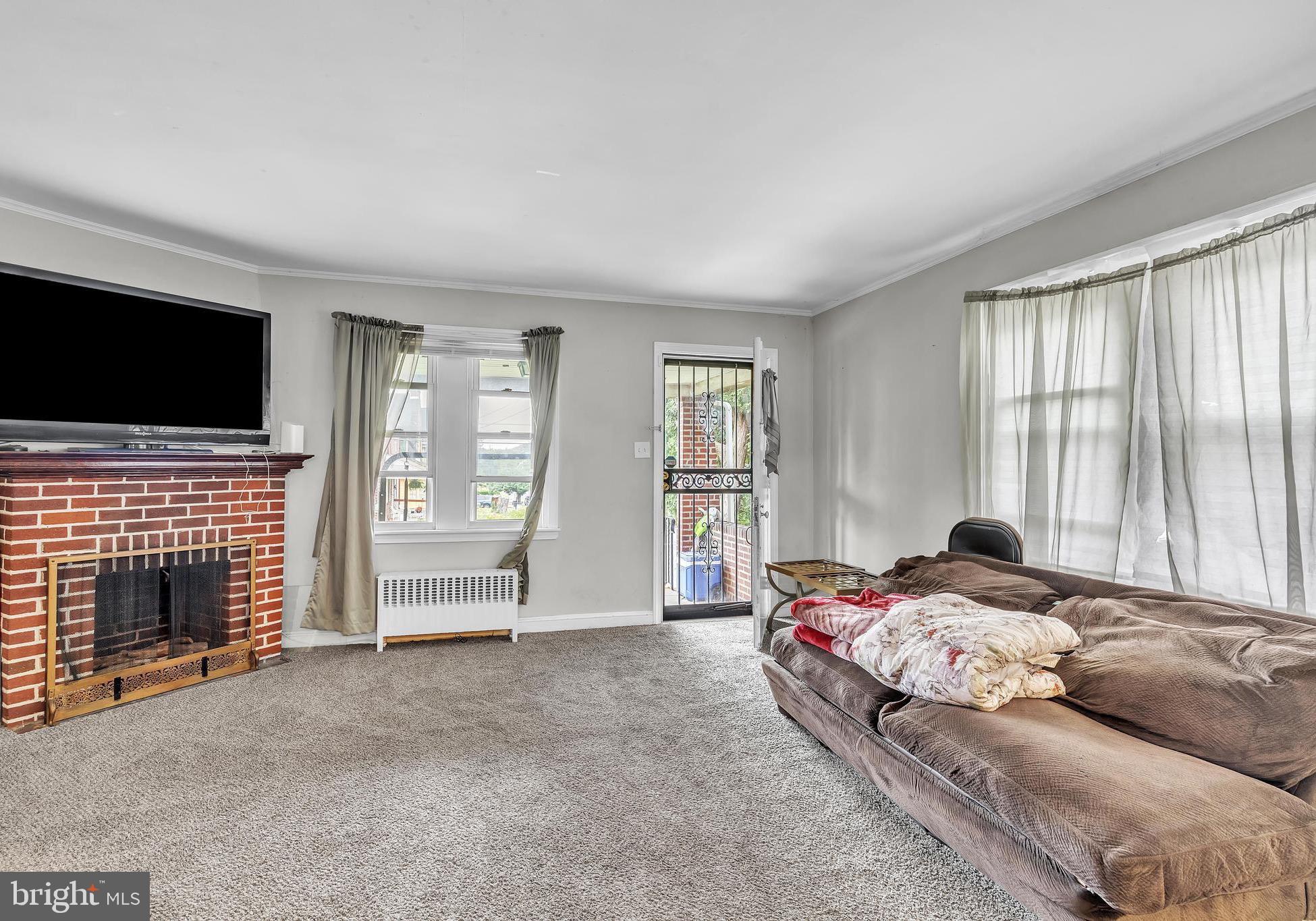 438 Holly Road Lansdowne, PA 19050 - Photo 2 of 17 a bedroom with a bed and a television