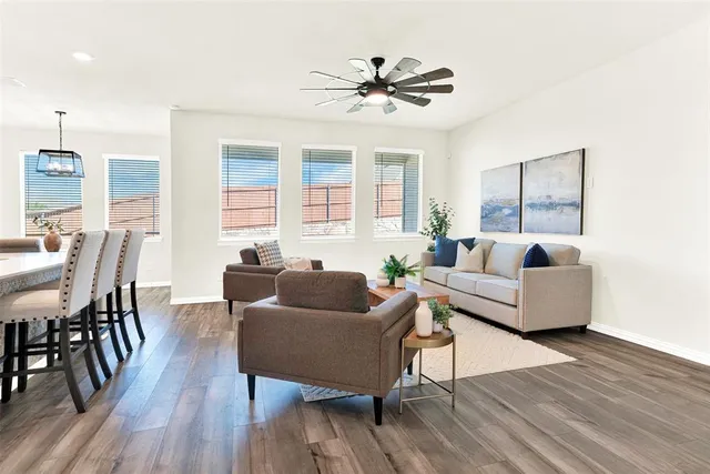 a living room with furniture and a wooden floor
