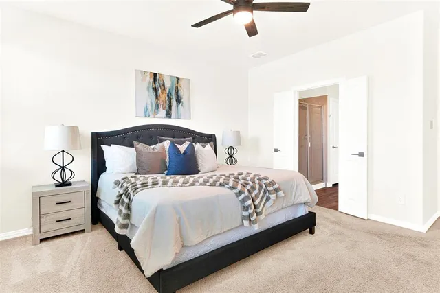 a bedroom with a bed and a night stand