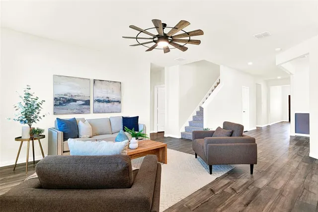 a living room with furniture and a large window