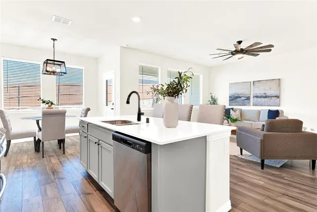 a living room with furniture a table and wooden floor