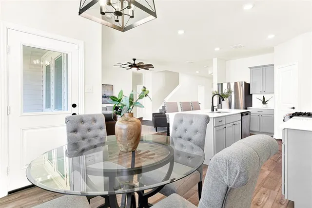 a dining room with furniture and a chandelier