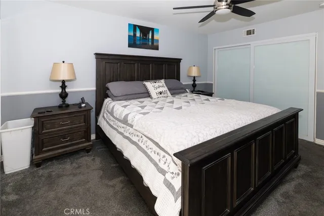 a bed sitting in a bedroom and dressers