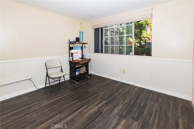 a view of a workspace with furniture and a window