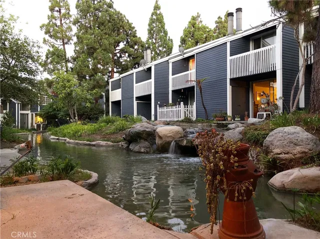 a view of a house with pool and a yard