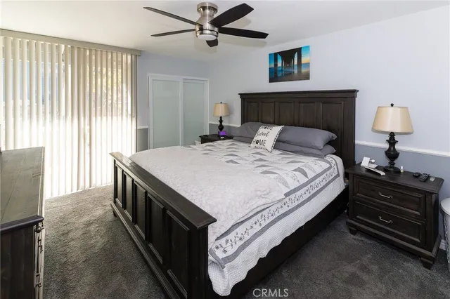 a spacious bedroom with a bed and a chandelier