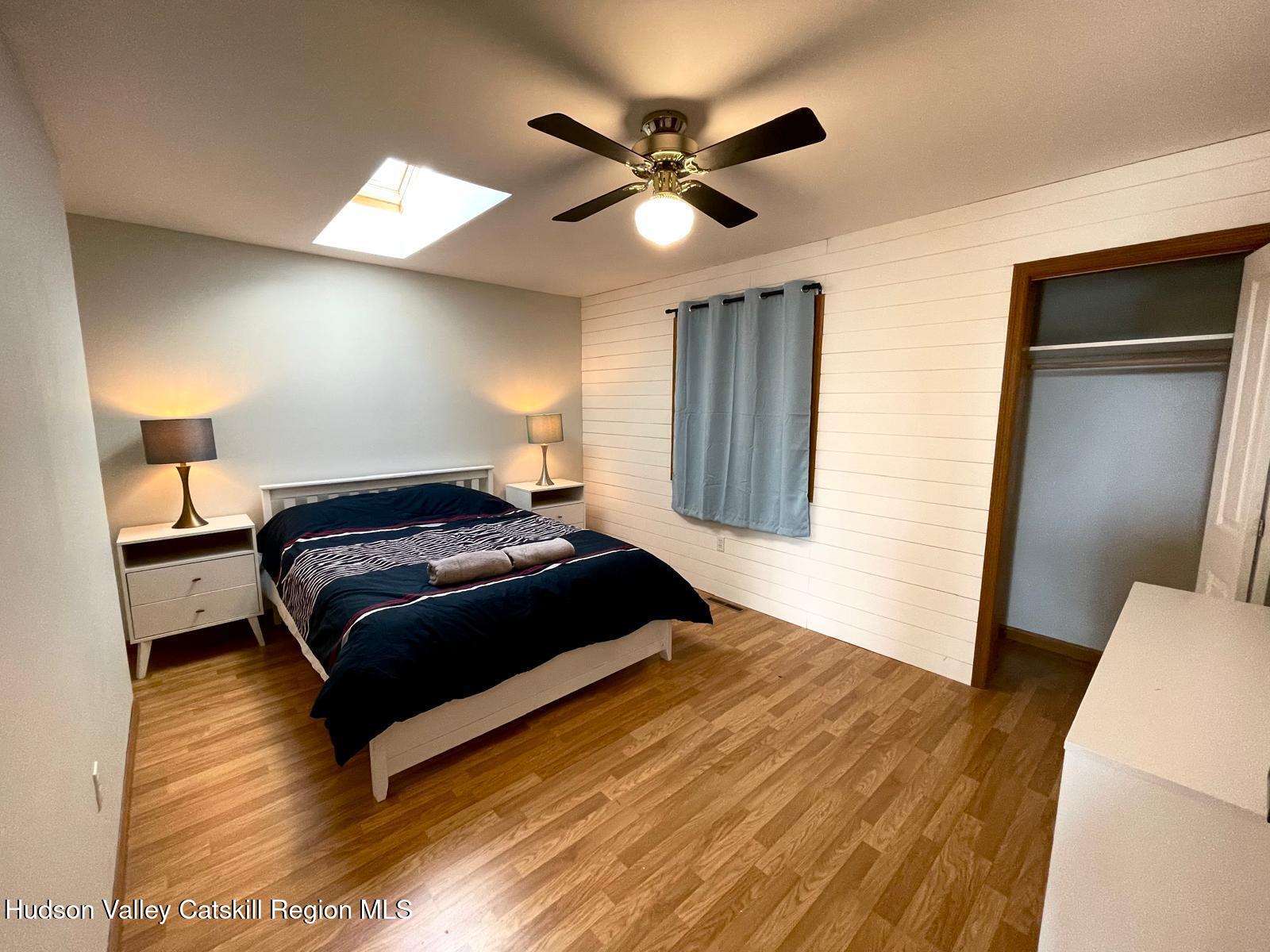 1367 Sleepy Hollow Road Athens, NY 12015 - Photo 11 of 28 a bedroom with a bed and a ceiling fan