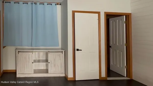a view of front door with wooden door