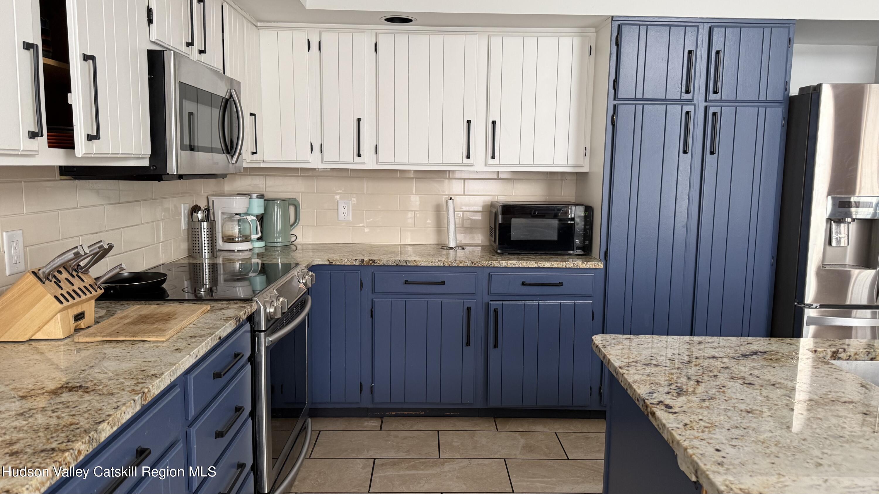 1367 Sleepy Hollow Road Athens, NY 12015 - Photo 6 of 28 a kitchen with stainless steel appliances granite countertop a sink dishwasher stove and refrigerator with wooden cabinets
