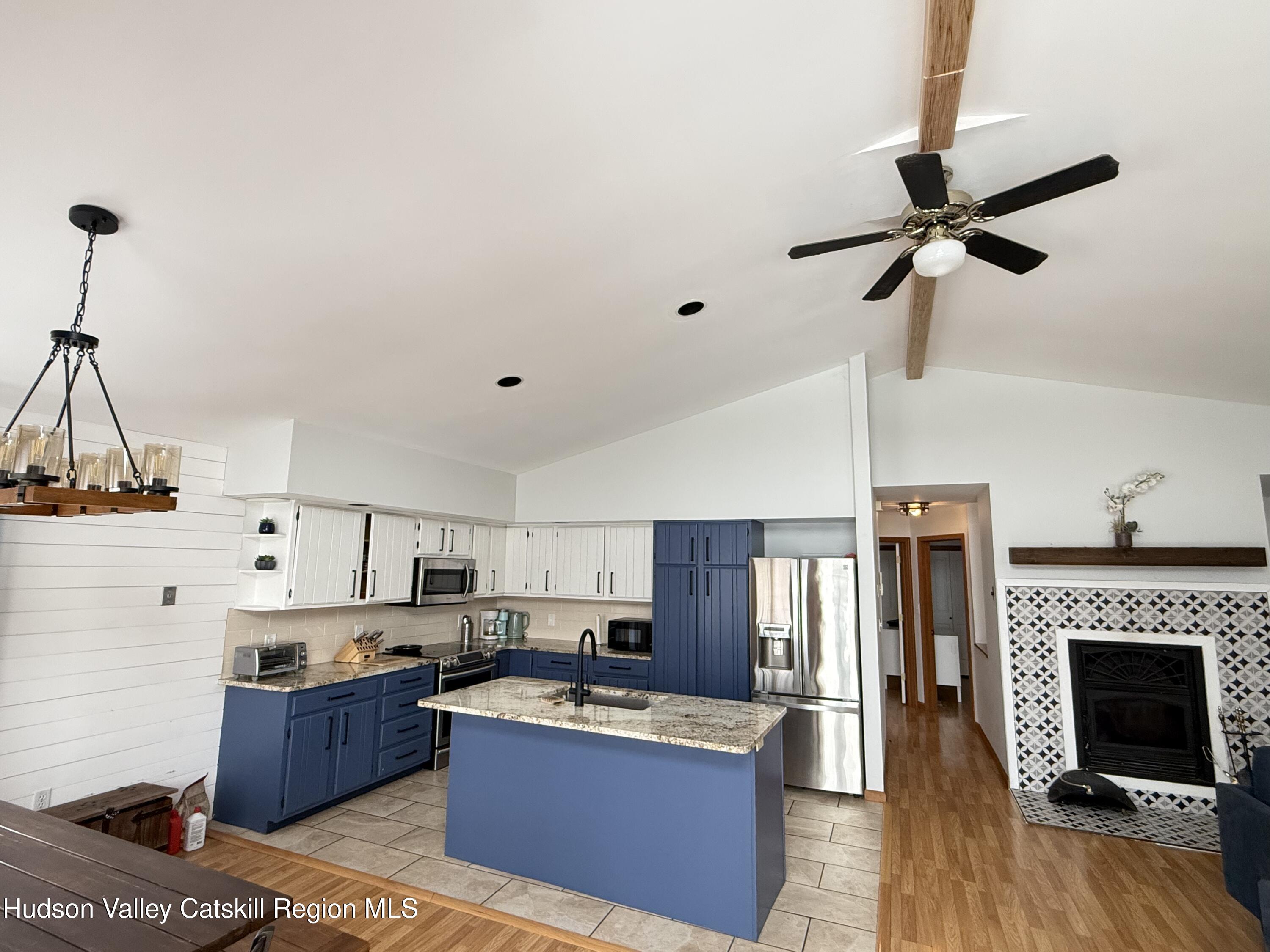 1367 Sleepy Hollow Road Athens, NY 12015 - Photo 7 of 28 a large kitchen with cabinets a counter and stainless steel appliances