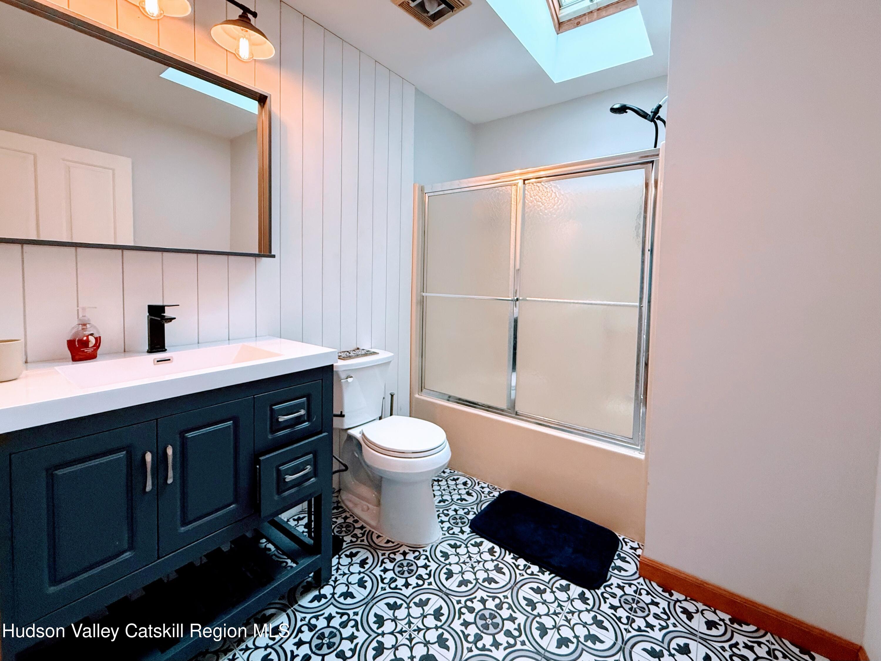 1367 Sleepy Hollow Road Athens, NY 12015 - Photo 9 of 28 a bathroom with a sink toilet vanity and shower