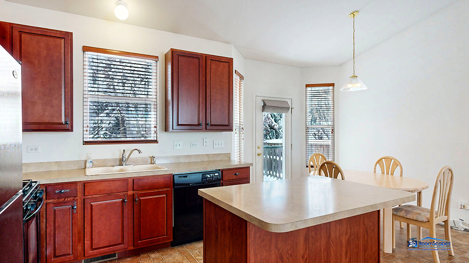 1829 Butterfield Road Woodstock, IL 60098 - Photo 7 of 43 a kitchen with stainless steel appliances granite countertop a sink a microwave cabinets and wooden floor