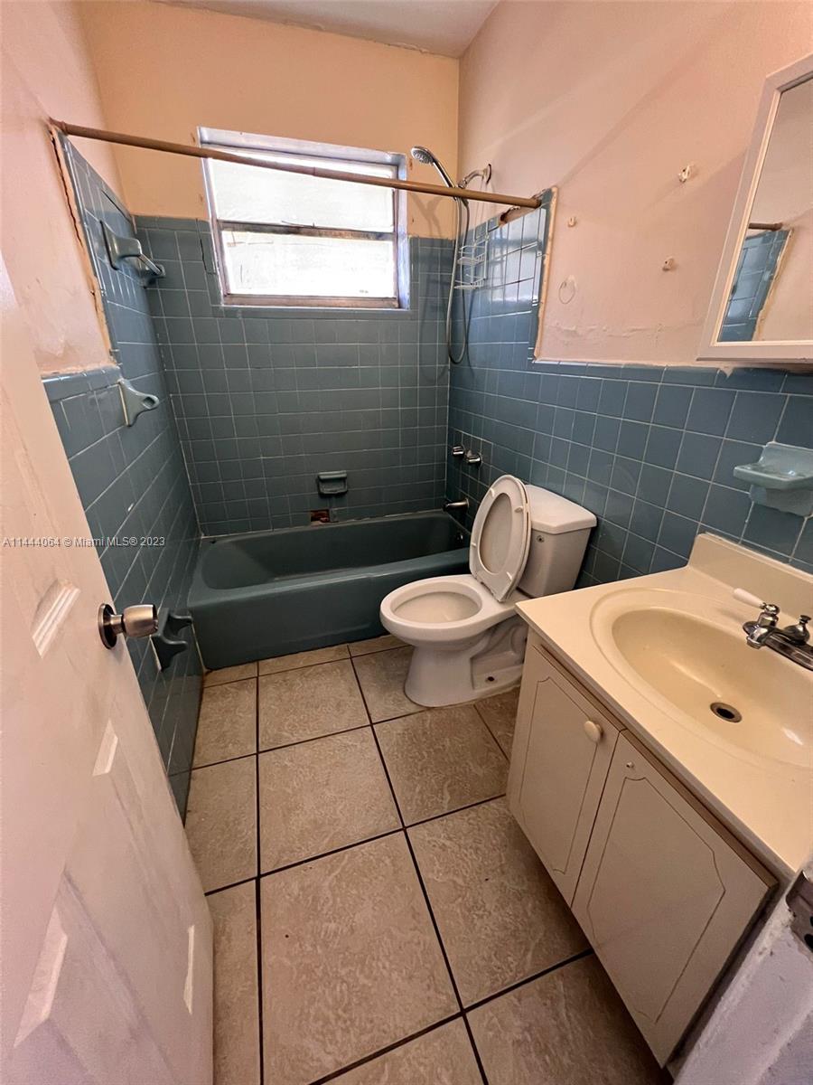 2315 Northwest 33rd Street, Unit 1 Miami, FL 33142 - Photo 3 of 7 a bathroom with a sink toilet and shower