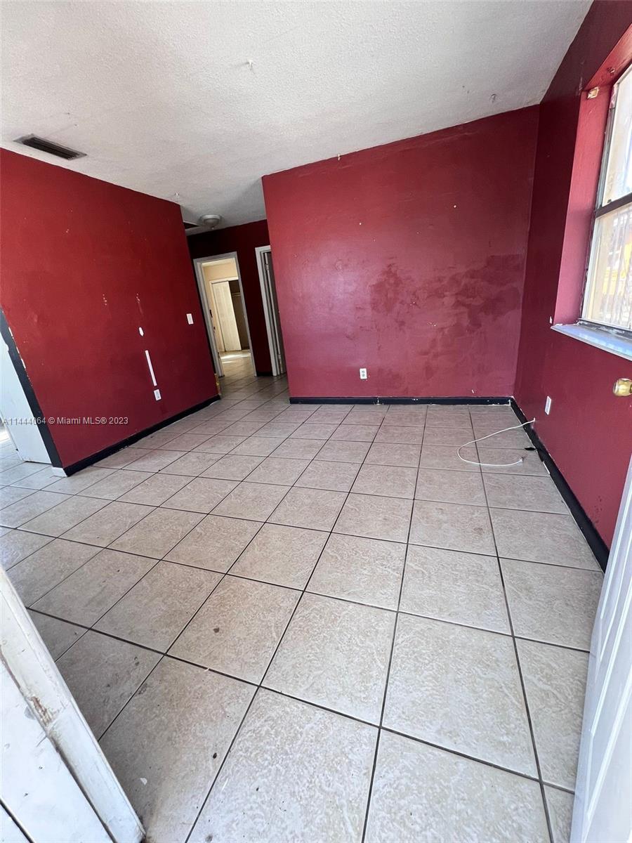 2315 Northwest 33rd Street, Unit 1 Miami, FL 33142 - Photo 6 of 7 a view of an empty room with a window