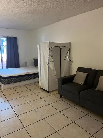 a living room with a couch and a walk in closet